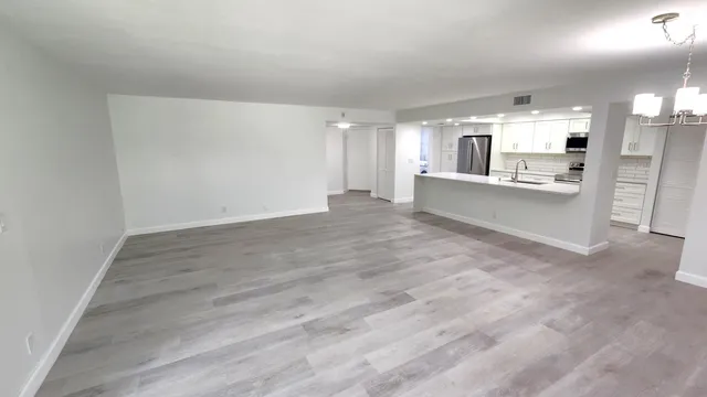 a view of a kitchen with a sink and cabinets
