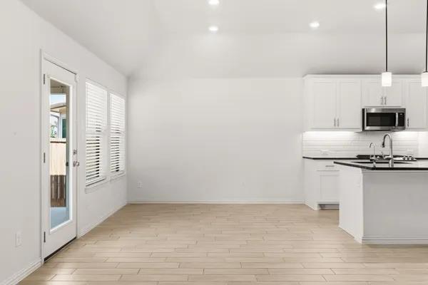 a kitchen with stainless steel appliances granite countertop a sink a stove and a refrigerator