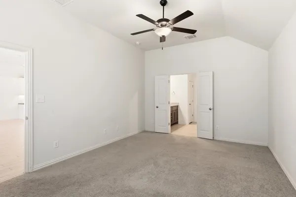 an empty room with a ceiling fan and a window