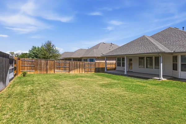 a view of a house with a yard and sitting area