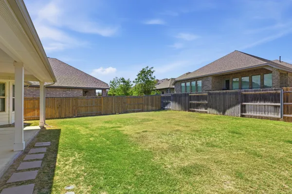 a backyard of a house with lots of green space