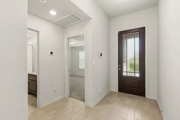 an empty room with closet and windows