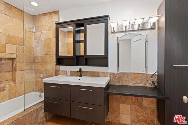 a bathroom with a sink and a mirror