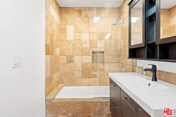 a bathroom with a sink a bathtub and a shower