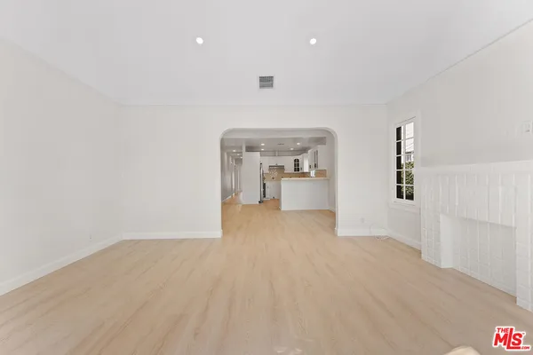 a view of a room with wooden floor