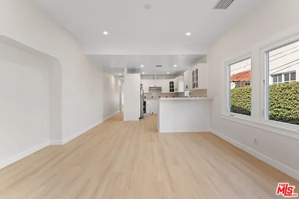 a view of a kitchen with a sink and dishwasher with wooden floor