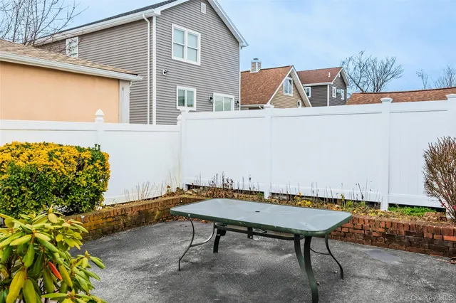 a backyard of a house with table and chairs