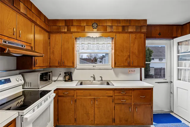 a kitchen with stainless steel appliances a sink and cabinets