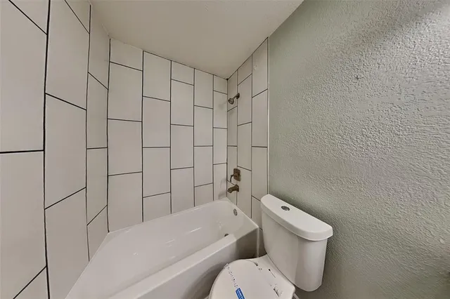 a bathroom with a toilet and shower