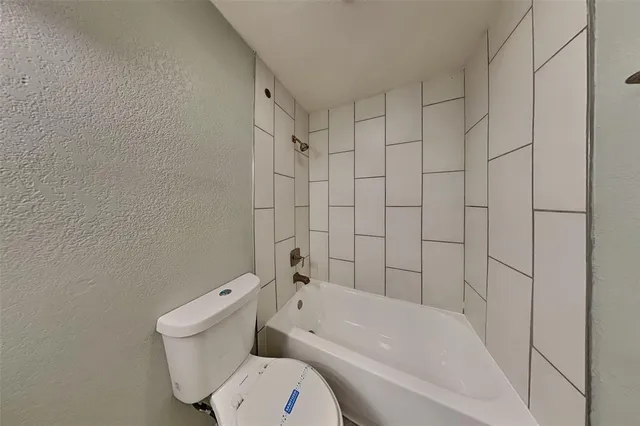 a bathroom with a toilet and bathtub