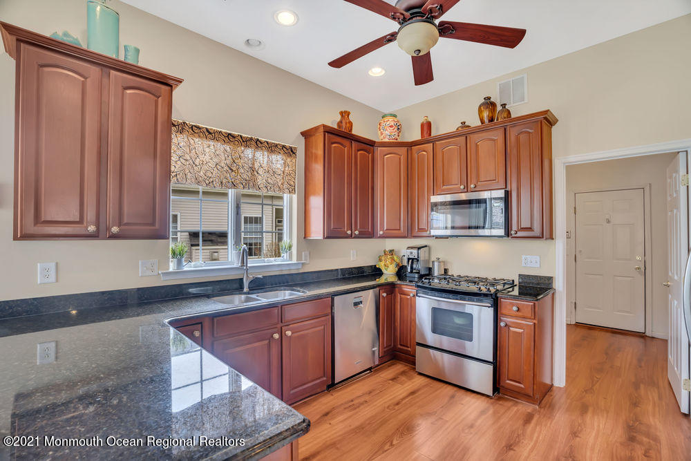 51 Pancoast Road Waretown, NJ 08758 - Photo 11 of 29 a kitchen with stainless steel appliances granite countertop a sink a stove cabinets and wooden floor