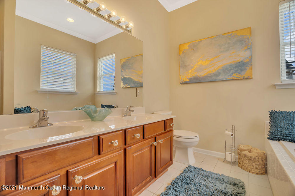 51 Pancoast Road Waretown, NJ 08758 - Photo 22 of 29 a bathroom with a sink a toilet and mirror