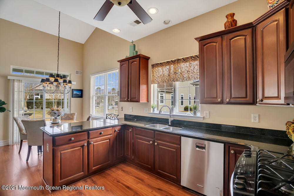 51 Pancoast Road Waretown, NJ 08758 - Photo 9 of 29 a kitchen with stainless steel appliances granite countertop a sink a stove and a wooden cabinets