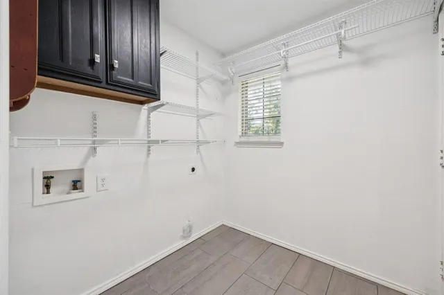 a large white kitchen with stainless steel appliances granite countertop lots of counter top space