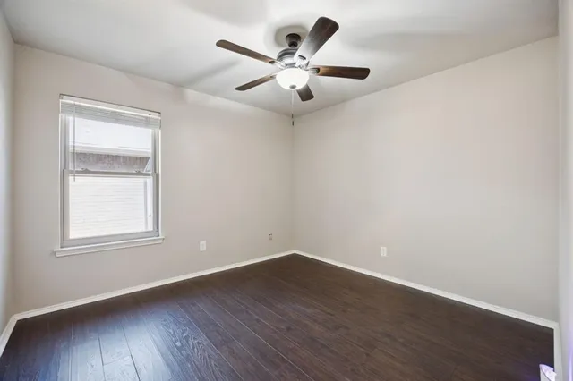 a spacious bathroom with a granite countertop sink mirror and bathtub