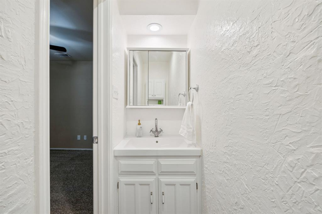 3104 Emerald Street Bedford, TX 76021 - Photo 19 of 25 half-bathroom attached to front bedroom