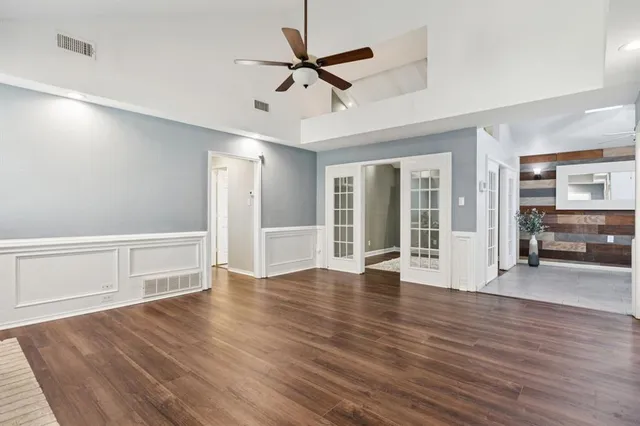 a view of a livingroom with wooden floor a fireplace and window