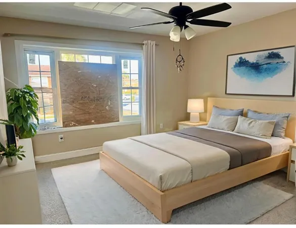 a bedroom with a large bed and a chandelier