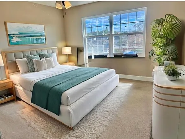 a bedroom with a bed and a window