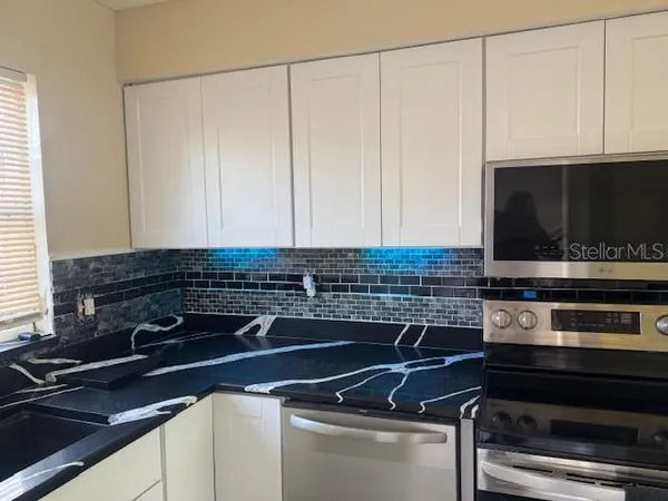 a kitchen with a stove and a microwave