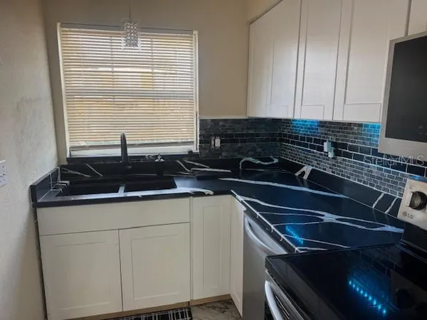 a kitchen with a sink and cabinets