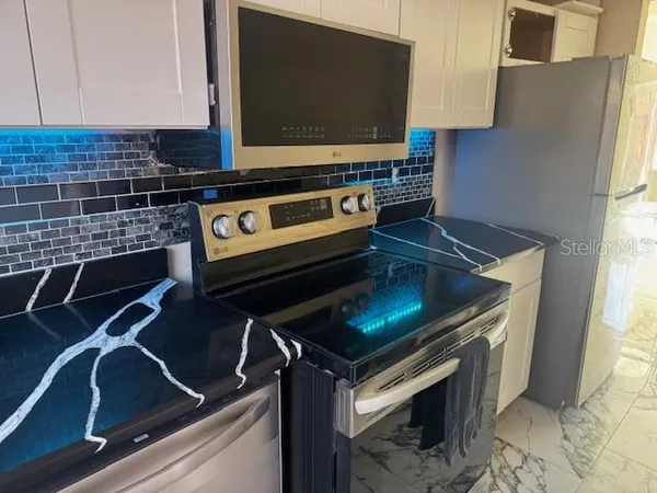a kitchen with a stove and a microwave