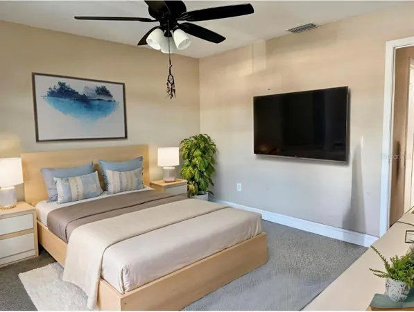 a bedroom with a bed and a flat screen tv