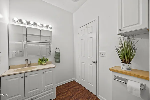 a bathroom with a sink a mirror and a shower