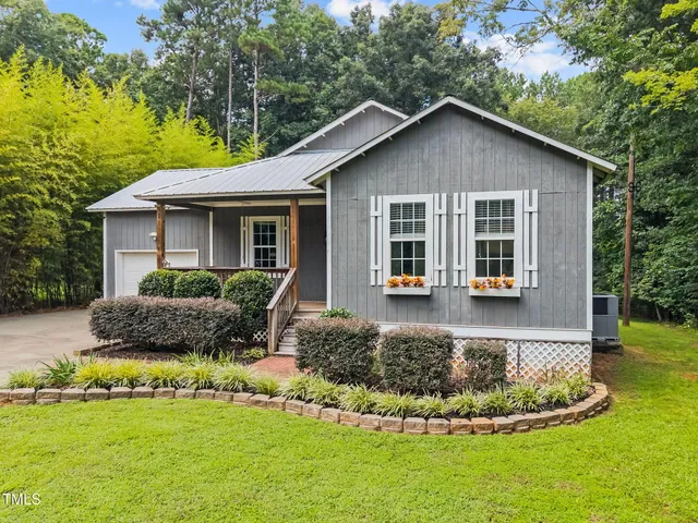 a view of a house with a yard patio and swimming pool