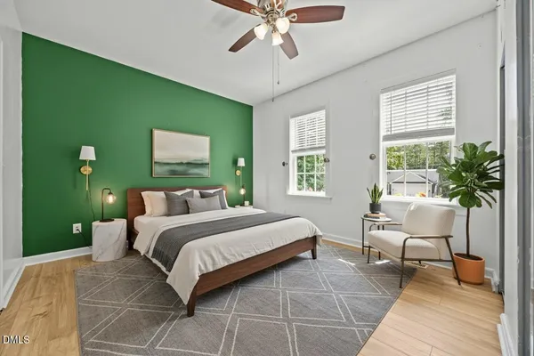 a bedroom with a bed and a potted plant