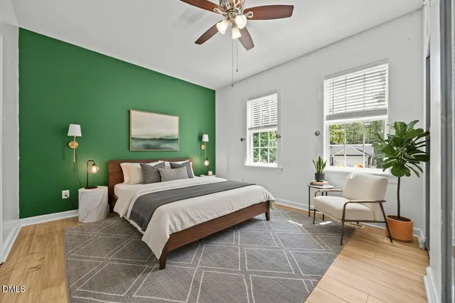 a bedroom with a bed and a potted plant