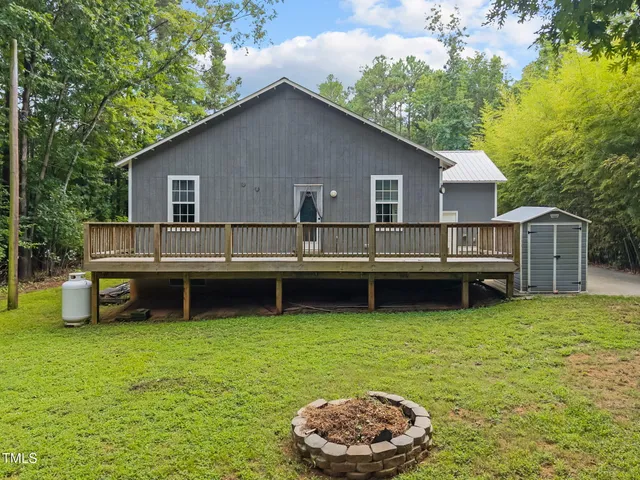 a view of a house with a yard patio and a swimming pool