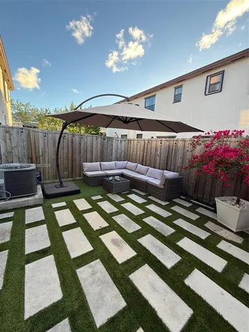 a view of a balcony with furniture and a potted plant
