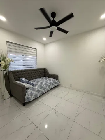 a living room with granite countertop furniture and a ceiling fan