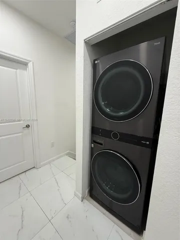 a bathroom with a double vanity sink toilet and shower
