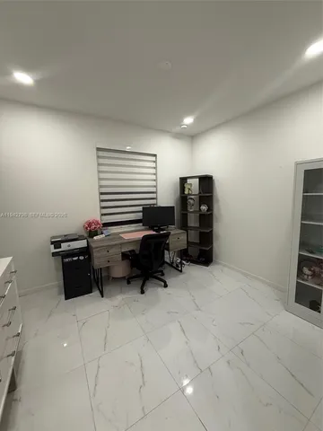 a room with furniture a flat screen tv and gym equipment