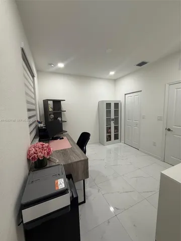 a room with a chair and cabinet