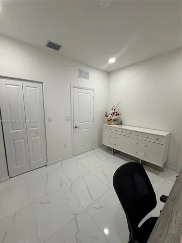 a view of a garden with a bench in the garden