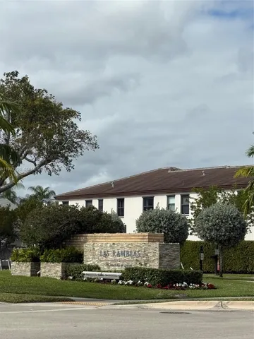 a swimming pool with outdoor seating and barbeque oven
