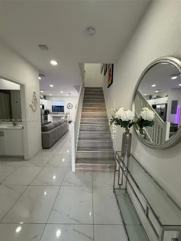 a lobby with furniture and stairs