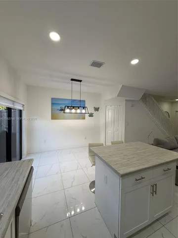 a kitchen with a sink a counter space and appliances