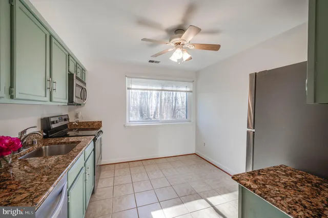 a kitchen with a stove cabinets and a stove top oven