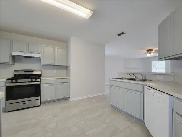 a kitchen with stainless steel appliances granite countertop a sink and a stove