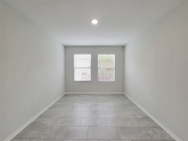 an empty room with windows and closet