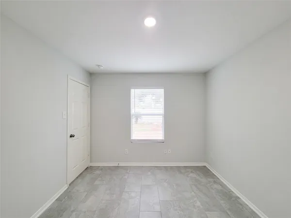 a view of an empty room with a fireplace