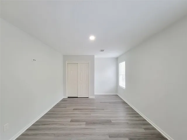 a view of an empty room and wooden floor