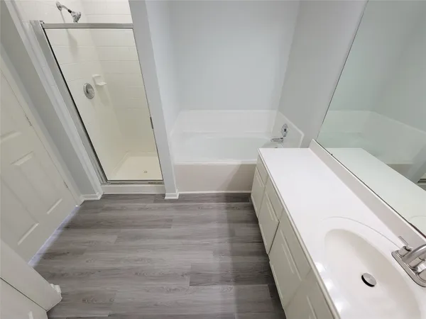 a bathroom with a bathtub and a shower