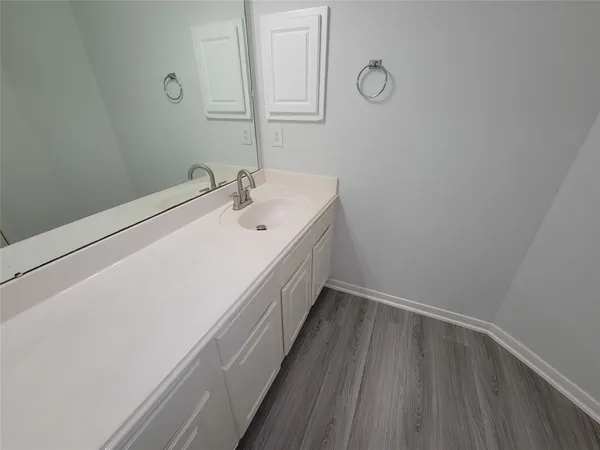 a spacious bathroom with a double vanity sink a mirror and a shower