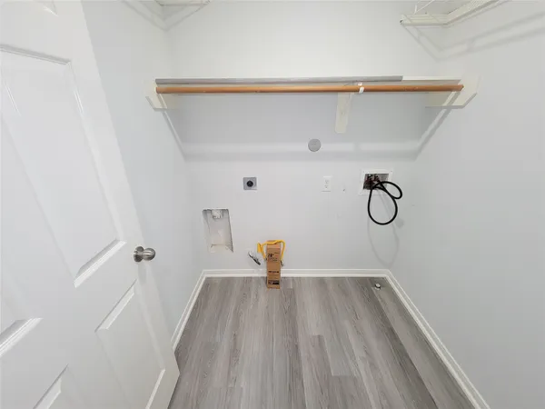 a view of a backyard with large trees and wooden fence