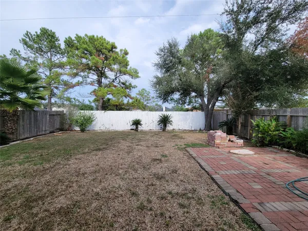 a front view of house with yard and trees